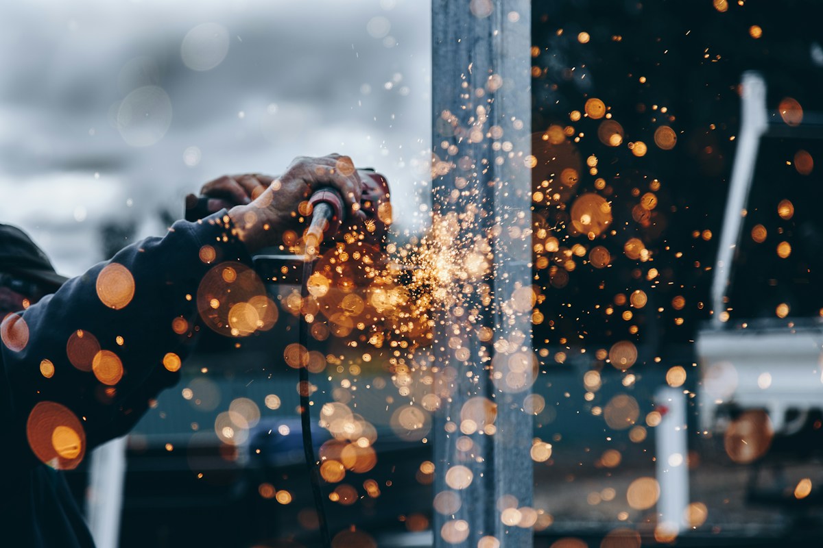 A skilled tradesperson working with metal